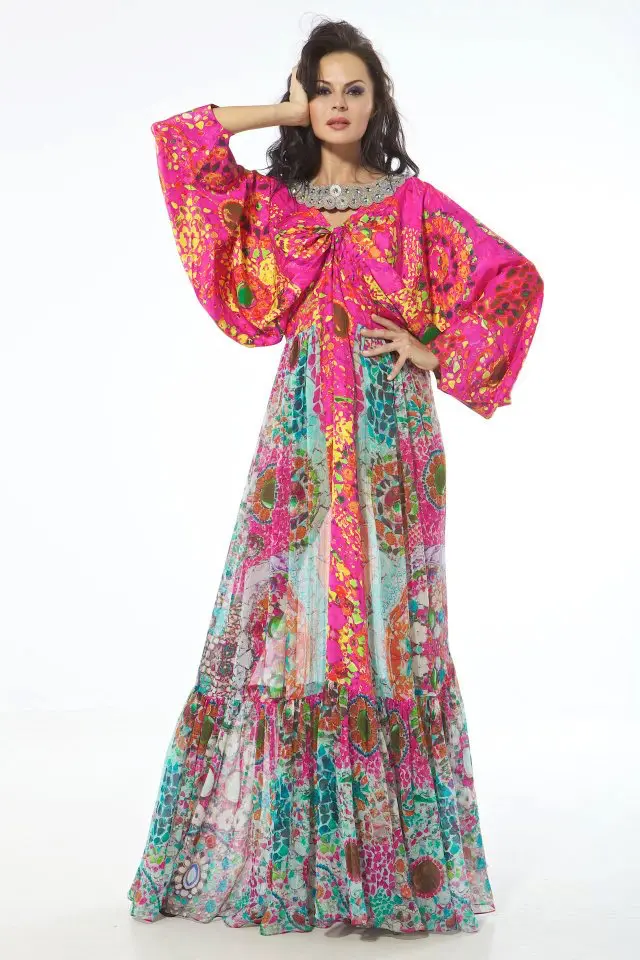 Model wearing a mixed-print designer kaftans in habutai silk and silk chiffon, with a boat neck embroidered in crystals and bolts, and Vionnet-inspired twisted kimono sleeves.